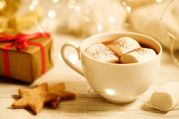 Hot chocolate with marshmallow on Christmas table background.