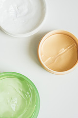 Jars of cream, aloe gel and moisturizing face patches on a white background. Nature Cosmetics for hand and face skin care, a means to reduce wrinkles, moisturizing. beauty and fashion.