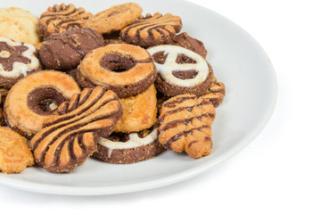 Different shortbread cookies on the dish close-up, selective focus