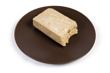 Piece of the sunflower halva on the brown dish