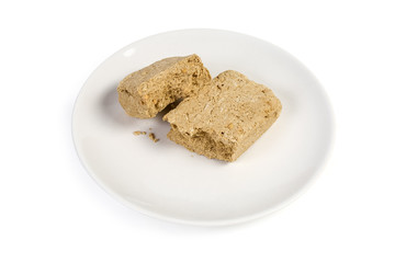 Pieces of the sunflower halva on the white dish