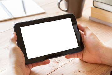 man hand using tablet computer on wooden table