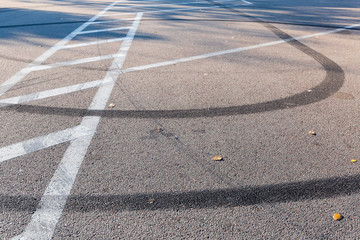 Tire tracks on the asphalt surface and road marking