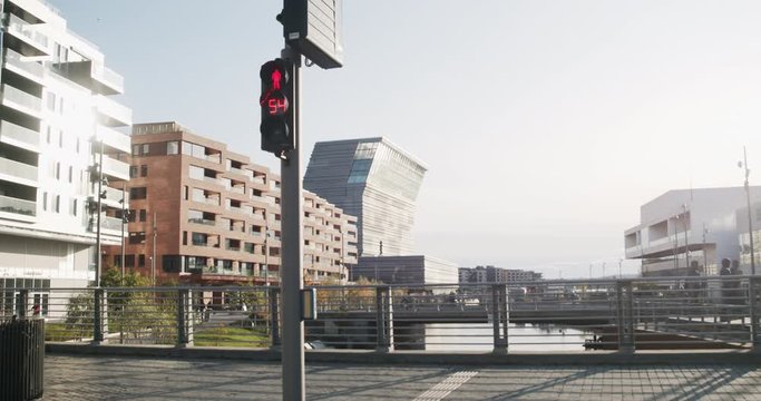 Cinema 4K gimbal wide shot with forward tilt motion of traffic light, Oslo Opera House and the Edvard Munch museum Lambda in the new Bj&oslash;rvika Opera quarter, in Oslo Norway.