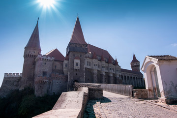 Corvin Castle or Hunyadi Castle in Hunedoara, Romania in bright sunlight.