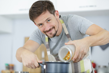 man boiling water for making pasta