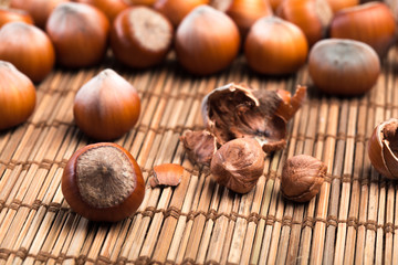 close up of hazelnuts on wooden table .