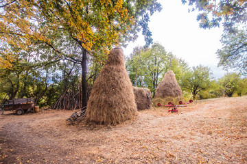 Traditional haystack at the rural farmland on an autumn day