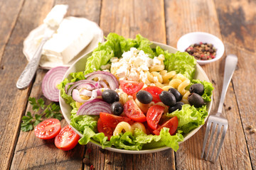 vegetable salad with pasta, olive, tomato, onion and feta