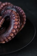 Octopus on a plate on a dark background