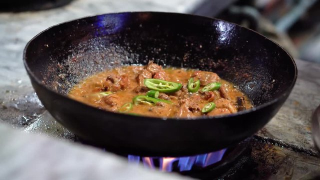 Green chilli added to traditional Indian, Pakistani handi - 4K