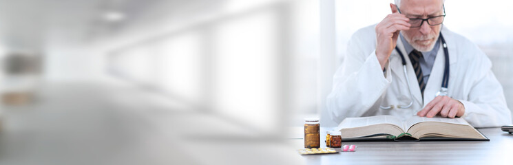 Doctor reading a textbook; panoramic banner