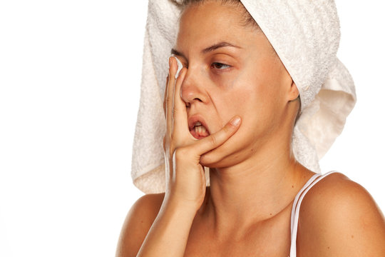 desperate young brunette covering her face with her hand