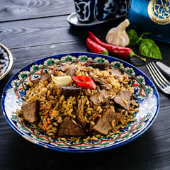 Bulgur with meat and vegetables on wooden table
