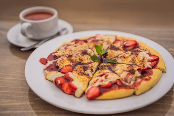 Delicious strawberry pizza on a balinese tropical nature background. Bali island, Indonesia