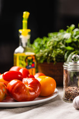 Traditional ingredients for cooking Italian pasta. Tomatoes, peppers, garlic, basil, olive oil. Close-up.