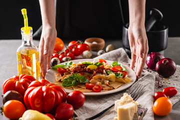 Italian traditional food. Homemade delicious pasta with tomatoes. Close-up.