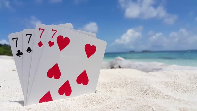 playing cards in the sand on thailand seashore