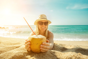 Happy Young Tourist  Smiling Caucasian Woman in hat with coconut