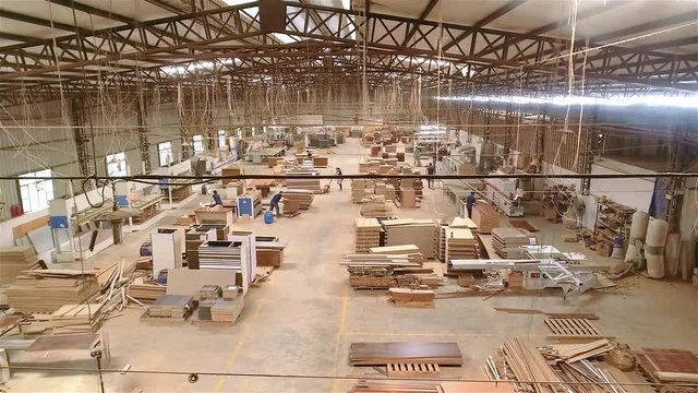 Panoramic view of a large furniture factory. People work in a furniture factory. Large furniture manufacturing plant