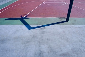     basketball hoop shadow silhouette on the red court on the street