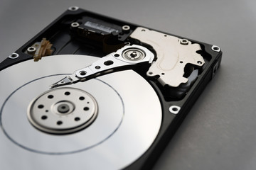 Close up of hard disk's internal mechanism hardware. Soft focus at middle and background.