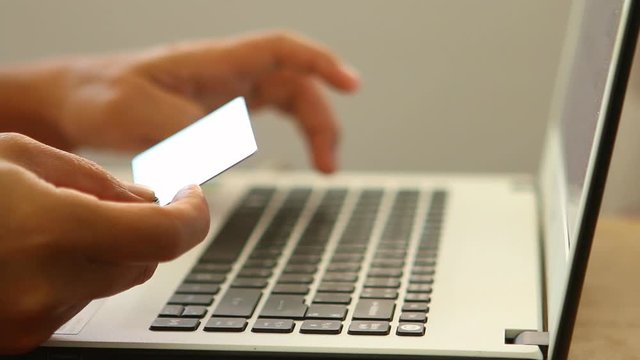 Man use credit card shopping online, indoor  Chiangmai Thailand