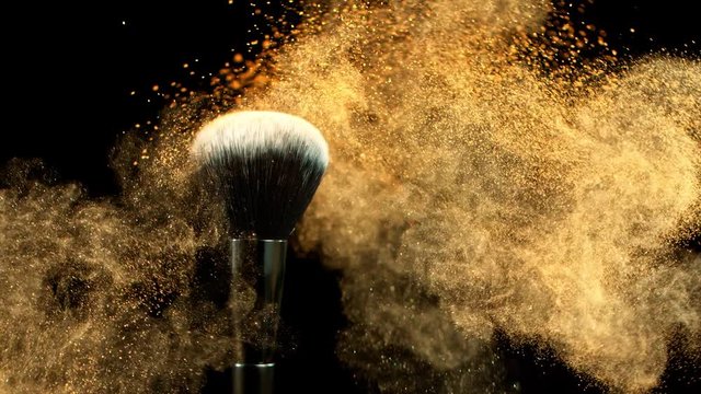 Super Slow Motion Shot of Makeup Powder Falling from Facial Brush at 1000fps.