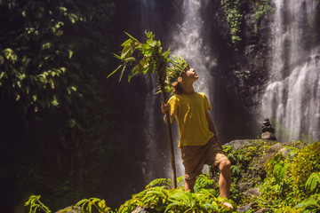 Cute boy depicts the king of the jungle against the backdrop of a waterfall. Childhood without...