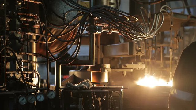Forms of insulators made of glass. Production of electric power insulators at the plant. Molten glass.