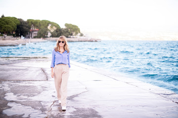 Fototapeta na wymiar Full length shot of attractive confident woman walking on the beach
