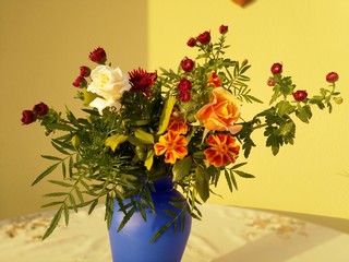 bouquet of flowers in vase on a yellow background