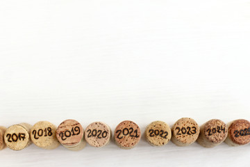 collection of wine corks of different years on the table top view. past and future winemaking