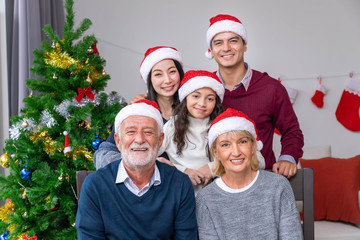 Portrait of happy extended multi generation family celebrate Christmas holiday festival together