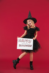 Cheery little girl witch in carnival halloween costume