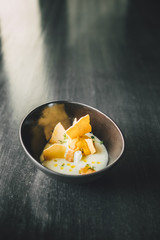 Delicious Vanilla dessert with cup of coffee on dark table