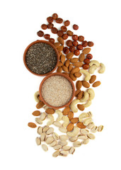 Organic Food Ingredients for a Low Carbohydrate Ketogenic Diet. Chia seeds, psilium, hazelnuts, almonds, cashews, pistachios, nuts isolated on a white background.