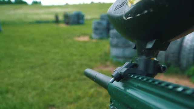 Gun shoots paint balls while playing paintball