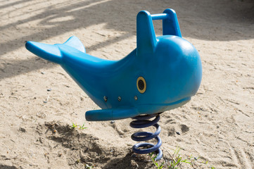 Blue fastener whales seat for children in park.