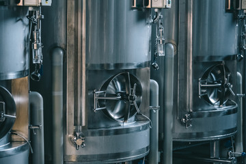 Craft beer brewing equipment in brewery! Metal tanks, alcoholic drink production