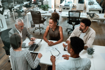 Top view of business people discussing something while working together in the modern office