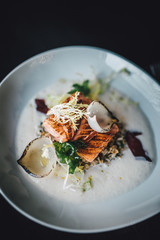 Restaurant chef prepared fish food on dark table. Organic fish food