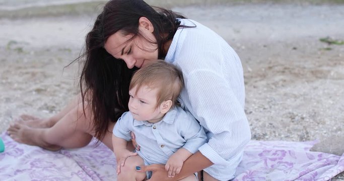 Child boy with mom on the beach