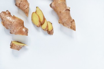 Top view of fresh ginger root sliced on white background.Healthy food and detox concept.Medical...