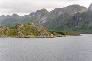 Fototapeta na wymiar green cliffs at southern end of Brakoya island, Norway