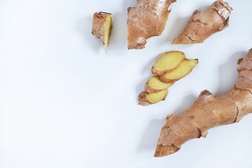 Top view of fresh ginger root sliced on white background.Healthy food and detox concept.Medical...