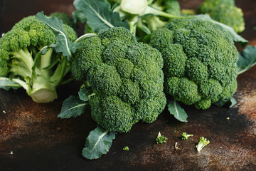 Fresh green broccoli on a dark brown background.