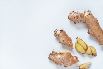 Top view of fresh ginger root sliced on white background.Healthy food and detox concept.Medical Products and Nutrition Ingredients.Сopy space for text.