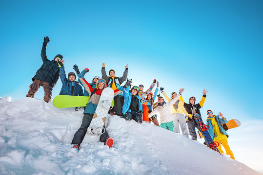 Big group of skiers and snowboarders at ski resort
