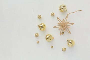 Christmas composition. New Year's composition. Golden star and balls on a light texture vertical background.